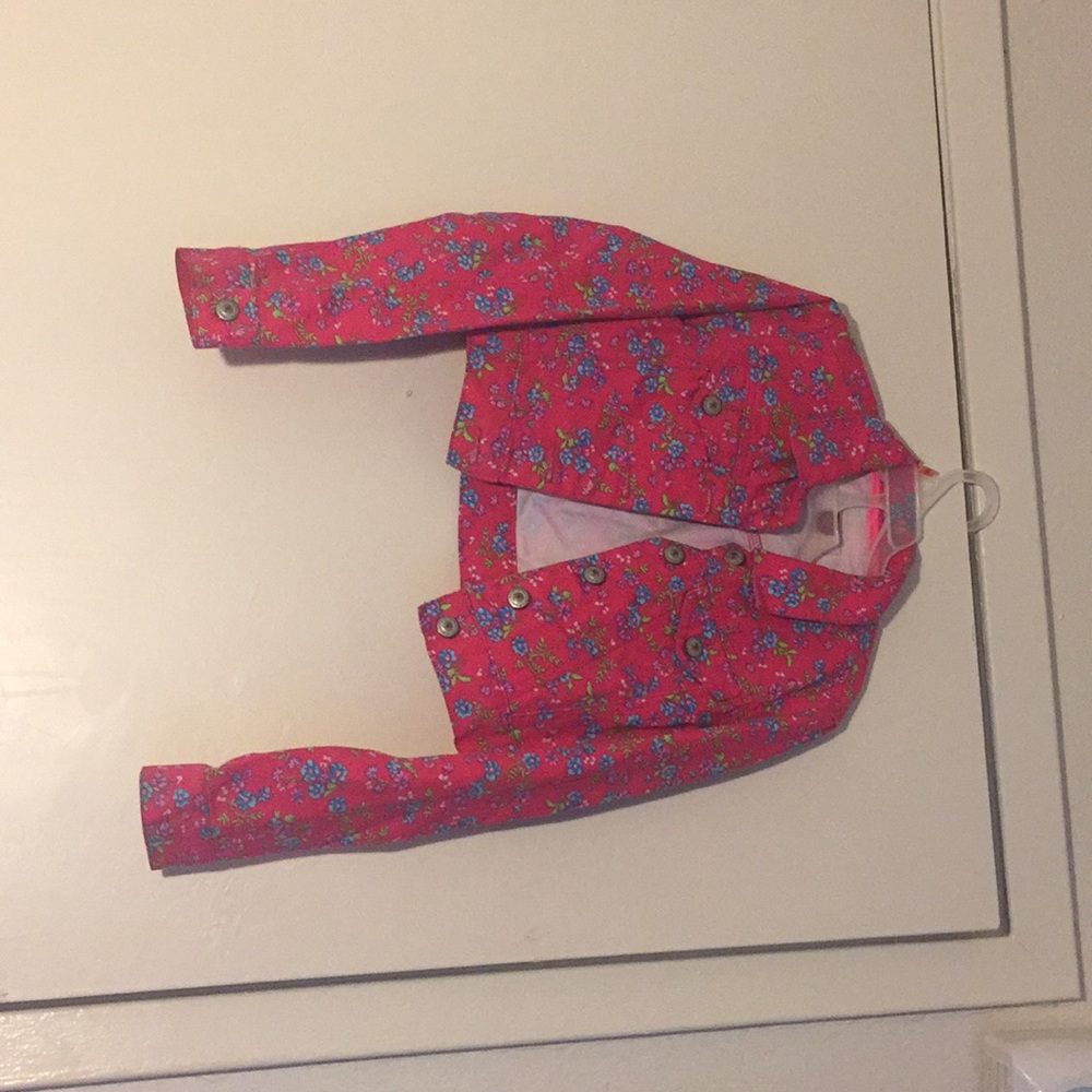 A pink flower blue jean jacket